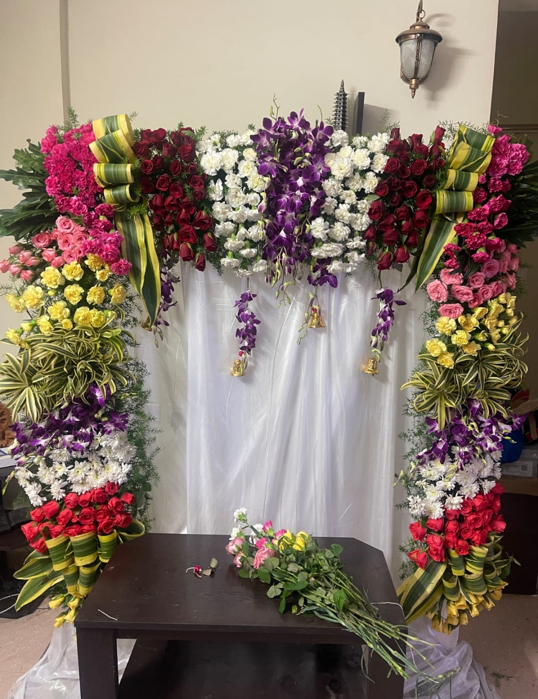 Multicolour flower arch with orchids and carnations