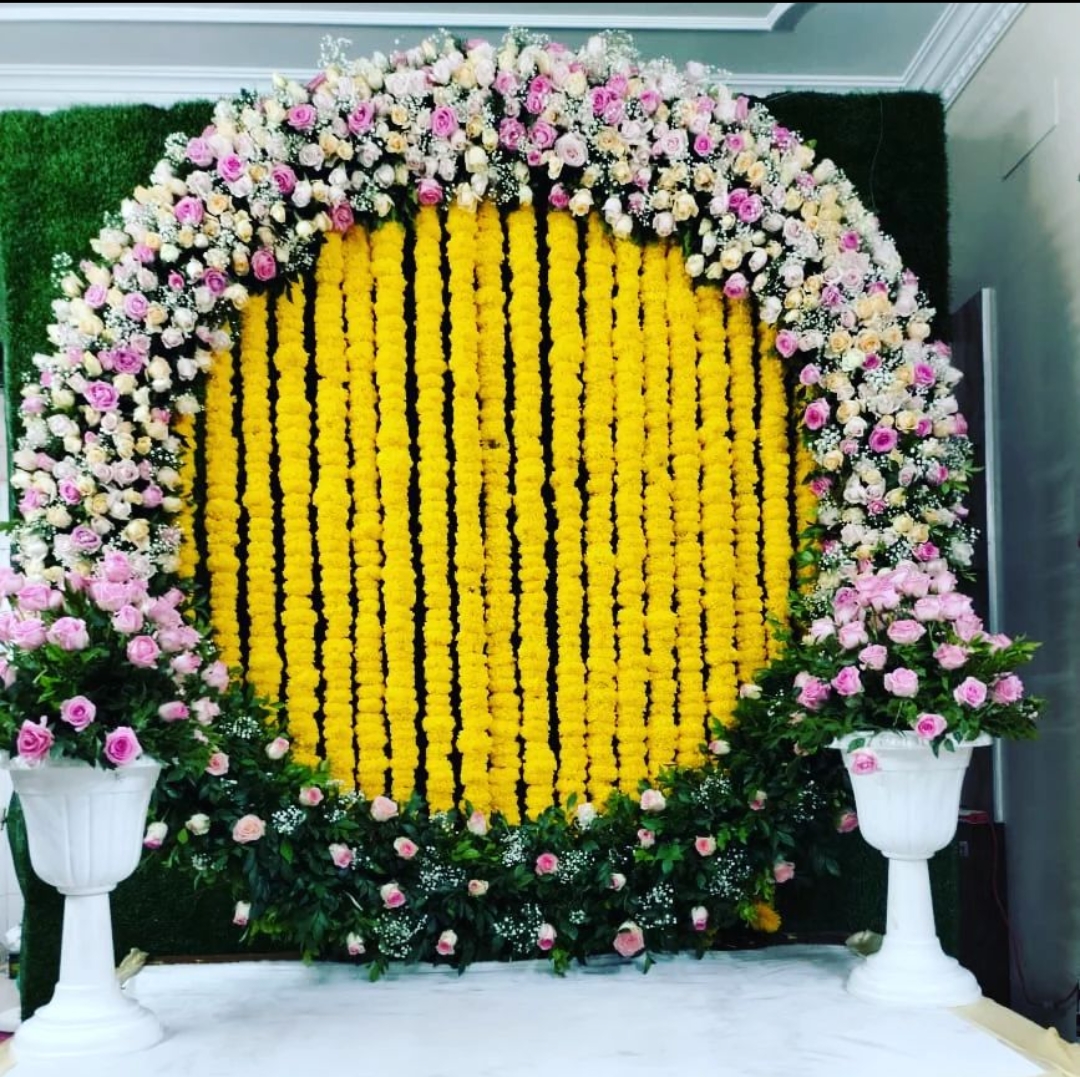 Marigold and rose circular backdrop for home function