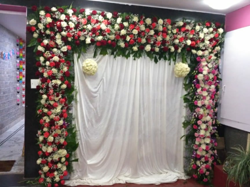 Red and white rose entrance arch with white drape