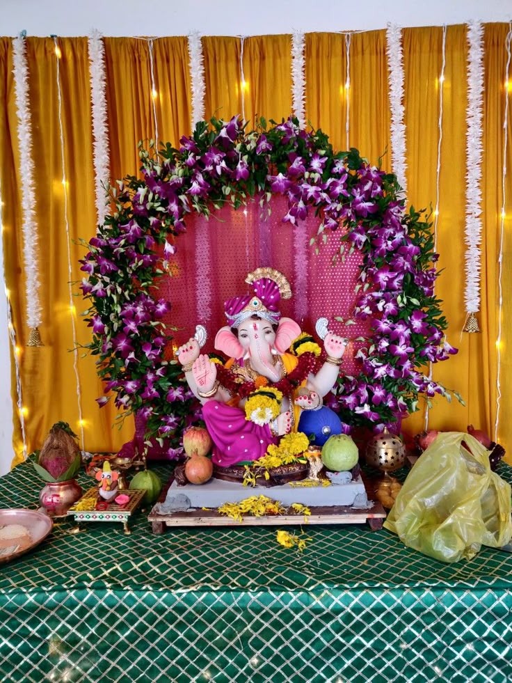 SF-36 — Ganesha decoration with purple orchid ring on golden curtain backdrop