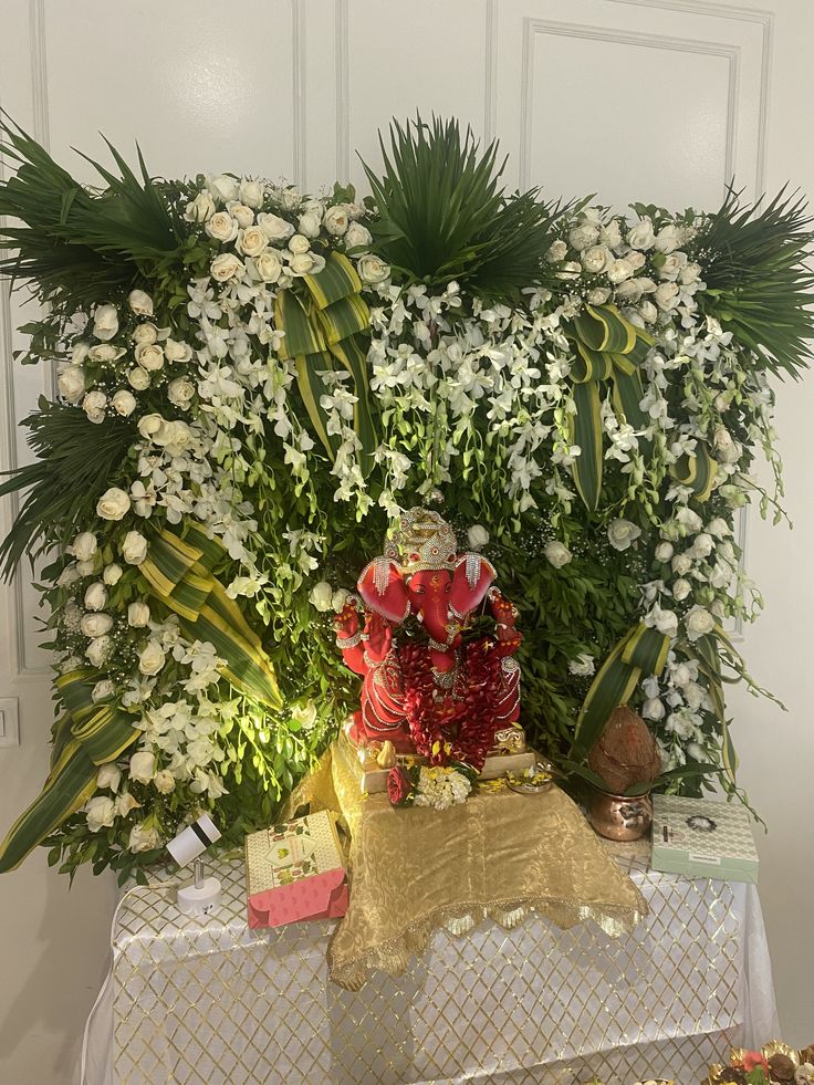 SF-56 — Ganesha decoration with white rose and palm leaf backdrop