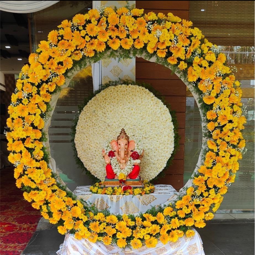 Ganesha festival ring decoration with yellow gerberas and jasmine backdrop