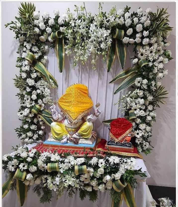 SF-34 — Ganesha pooja frame decoration with white roses and green leaves