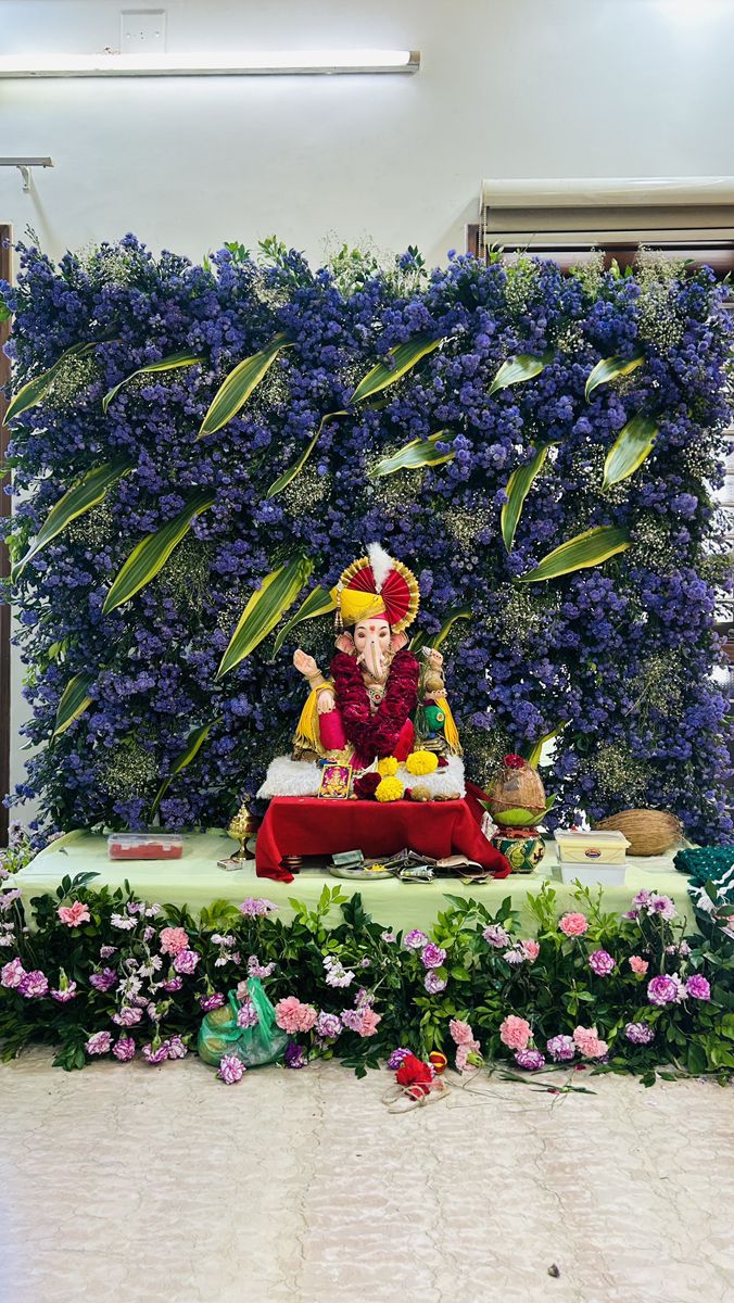 SF-70 — Ganesha decoration with blue flower wall backdrop and carnation table border