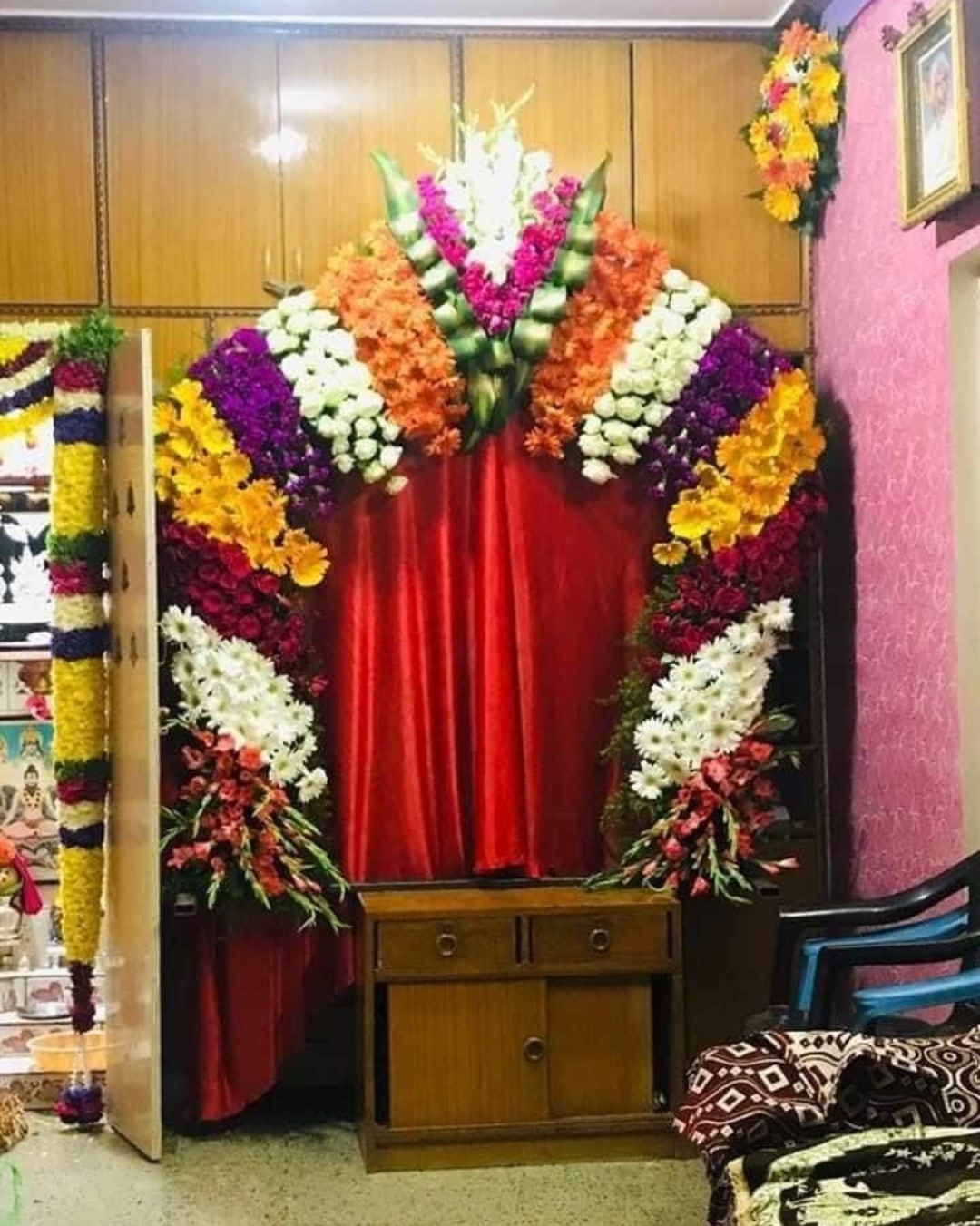 Pooja room flower arch decoration with mixed seasonal flowers