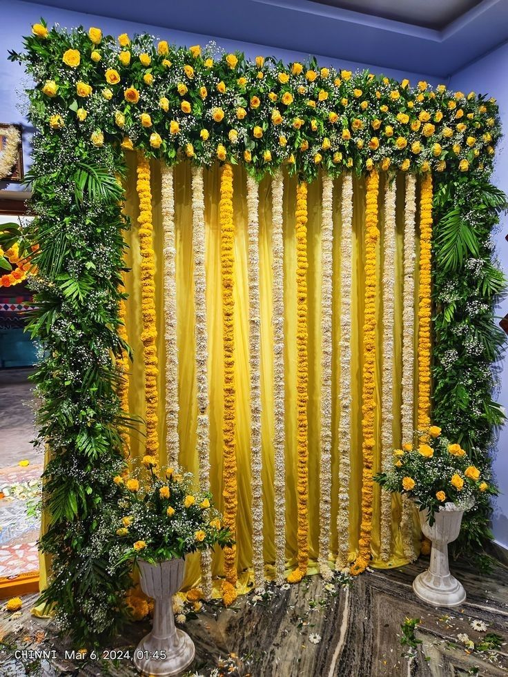 SF-68 — Yellow rose and marigold garland backdrop with flower vases